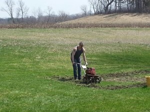 Jeff tilling up a garden spot.