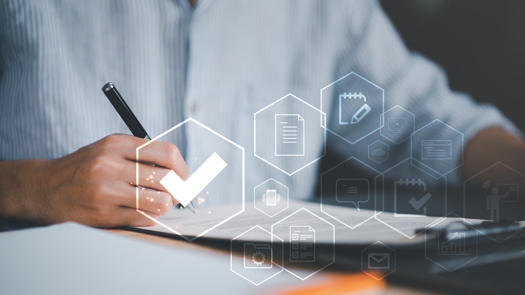 Man audits documents with a checklist, plan review process. 